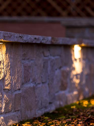 outdoor stone wall with lighting