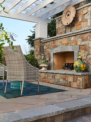 large outdoor fireplace under white overhang