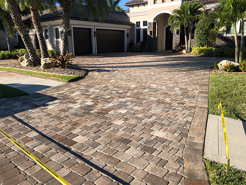 paver driveway behind yellow construction tape