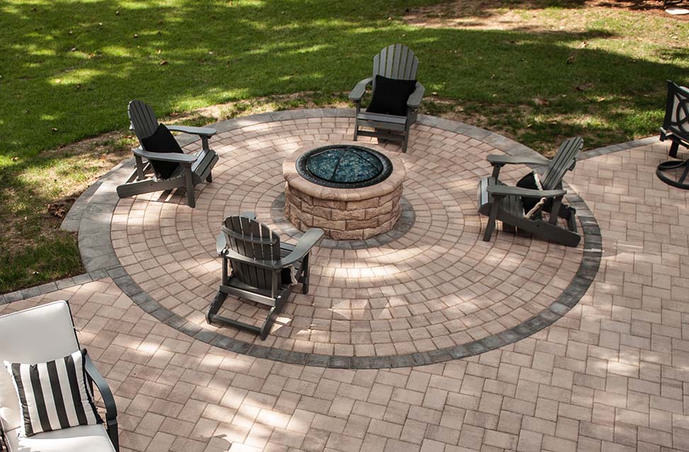 patio with firepit and four chairs around it.