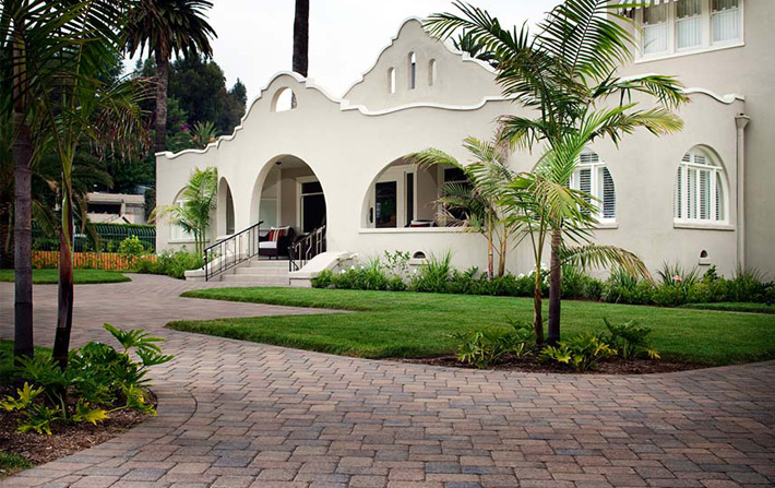 paver walkway in front of white spanish building