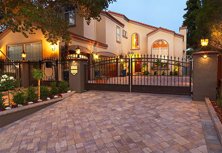 Luxury paver driveway with gated fence