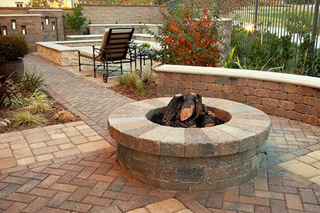 exstinguished fire pit with retaining wall around